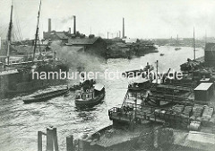 Blick über den Reiherstieg in Hamburg Steinwerder - Fabrikschlote im Hintergrund - Schlepper ziehen Schuten.