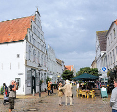 Touristenstädtchen Friedrichstadt - Backsteinrenaissance, Fussgängerpassage mit Touristen; Café auf dem Gehweg.