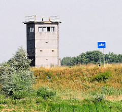 Ehem. Wachturm der DDR am Elbufer bei Neu Darchau - Hinweisschild für die Schifffahrt auf eine Fähre, die die Elbe kreuzt.