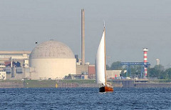 Das Kernkraftwerk am Elbufer bei Stade wurde 1972 in Betrieb genommen und 2003 stillgelegt. Seitdem wird es "zurückgebaut" - rechts das Leuchtfeuer am Stader Sand; ein Segelschiff kreuzt auf der Elbe.