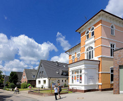 Alte und neue Architektur an der Marktstrasse in Barmstedt, Kreis Pinneberg - Gründerzeitgebäude und Einzelhäuser mit Spitzdach, Fussgänger.