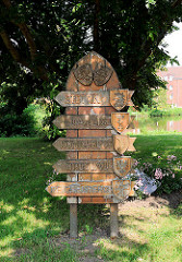 Holzschild mit deutschen Städtenamen in Polen an der Stolpmünder Eiche in Glückstadt.