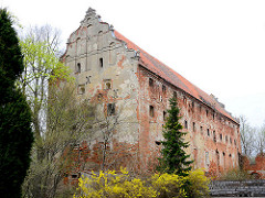 Ruine Schloss, Burgruine in Mehlsack / Pieniężno, Polen. Ziegelgebäude, Backsteinarchitektur, der Putz ist abgeblättert.