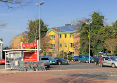 Parkplatz eines Supermarkts in Uetersen - im Hintergrund das Rathaus Tornesch, direkt an der Grenze zu Uetersen gelegen; die beiden Gemeinden Tornesch + Uetersen haben einen Zusammenschluss diskutiert, der in einem Bürgerentscheid von Tornescher Seit