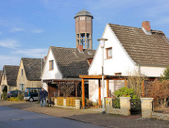 Einzelhäuser mit Spitzdach in der Birkenalle von Uetersen im Kreis Pinneberg - im Hintergrund der Wasserturm.