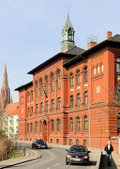 Fritz-Reuter-Schule / Rote Schule in der Hansestadt Demmin - Ziegelfassade, Uhrenturm - Kupfer; lks. im Hintergrund der Kirchturm der St. Bartholomaeikirche.