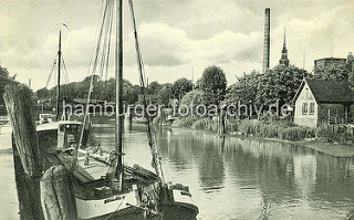 Altes Bild vom Hafen in Itzehoe, ein Ewer liegt an der Kaimauer - im Hintergrund die Kirchturmspitze der  Itzehoer St. Laurenti-Kirche.