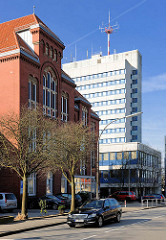 Gebäude der Auguste Viktoria Schule in Itzehoe, dahinter der Neubau des mehrstöckigen Polizeigebäudes.