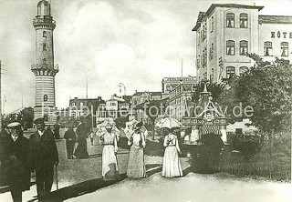 Bilder vom historischen Warnemünde - Touristen an der Uferpromenade, ca. 1910; im Hintergrund der 1898 gebaute Leuchtturm.