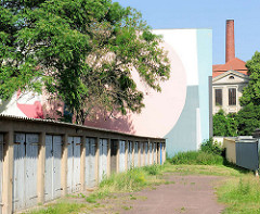 Garagen im Hinterhof, moderne Wandmalerei - Fabrikschornstein; Bilder aus Magdeburg.