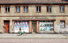 Leerstehendes Gewerbegebäude mit vernagelten Schaufenstern / Werbeplakate - Klempnermeister; Archtiektur in Brandenburg an der Havel.