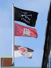 Hamburg Flagge und Fahnen des Fussballclubs FC St. Pauli am Millerntorstadtion.