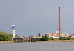 Bilder aus Hamburg Wilhelmsburg - Einfahrt zum Veringkanal - Hochwasserschutzanlage - re.Öltanks und ein hoher Fabrikschornstein - lks. eine Radaranlage im Reiherstieg.