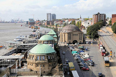 Blick über die Kupferdächer der St. Pauli Landungsbrücken und Gebäude des alten Elbtunnels. Parkplätze für Autos und Reisebusse.