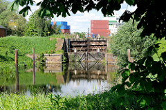 Historische Schleuse des Schmidtkanals in Hamburg Wilhelmsburg - Containerlager im Hintergrund.