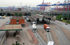 Zollstation Hamburg Waltershof - Zollgrenze im Hamburger Hafen / Freihafen; Sattelschlepper mit Containern passieren die Zollgrenze  - im Hintergrund Containerkräne am Walteshofer Hafen.