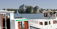 Hausboote am Ufer des Röblinsees in Fürstenberg (Havel) - Fabrikruine am Seeufer.