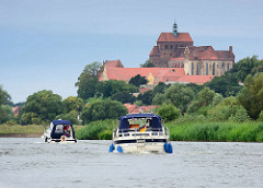 Blick von der Havel zum Domberg der Hansestadt Havelberg - Motorboote fahren havelabwärts.