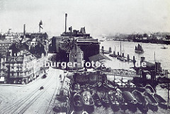 Bild vom alten Altonaer Holzhafen. Schuten liegen mehrere Reihen tief im Altonaer Hafenbecken - eine Wassertreppe führt zum zum Anleger. Industriegebäude am Elbufer; Wohn- und Gewerbehäuser an der Grossen Elbstrasse.