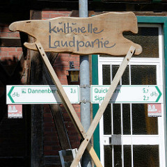 Schild Kulturelle Landpartie, Hinweisschilder für RadfahrerInnen nach Dannenberg, Quickborn und Sipnitz.
