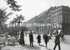 Fussgänger / Fussgängerin auf dem Jungfernstieg in der Hamburger Innenstadt / Neustadt. Fahrradfahrer und Kfz auf der Strasse - Palmen in Töpfen vor dem Alsterpavillion.