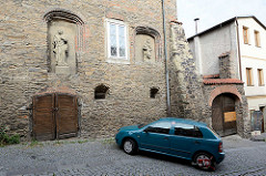 Historische religiöse Reliefs an der Fassade vom Dekanatsgebäude in Kolin - Auto im Parkverbot mit Parkkralle.