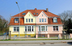 Doppelhaus - Wohnhaus mit unterschiedlich farbig gestalteter Fassade; Siemser Landstrasse, Hansestadt Lübeck.