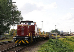 Auf dem Rangierbahnhof von Hamburg Rothenburgsort rangiert eine Güterlokomotive offene Güterwaggons auf den Gleisen.