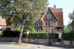 Mehrstöckiges Wohnhaus mit Ziegelfassade,  symmetrisch angeordnete Risalite mit Spitzgiebel / Kleekamp in Hamburg Fuhlsbüttel.