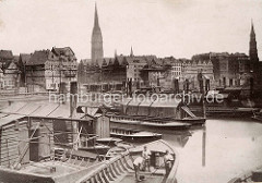 Historische Fotografie von der Hamburger Altstadt; Arbeitsboote liegen im Binnenhafen, Ewerführer / Bootsleute schrubben ihr Schiff.