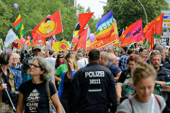 Demonstrationszug am 08. Juli gegen G20 in Hamburg - rote und bunte Fahnen.