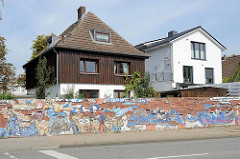 Wohnhäuser an der Volksparkstrasse in Hamburg Stellingen - alte Ziegelmauer mit abgeblättertem Putz, Grafitti HSV supporter.