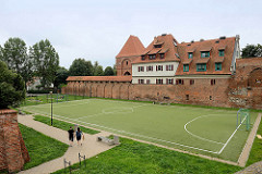 Historische Burgmauer der ehem. Ordensburg Thorn - Sportplatz und Hotelneubau.