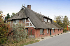 Wohnwirtschaftsgebäude / Fachwerkhaus mit Reetdach in der Heinrich-Osterath-Straße im Hamburger Stadtteil Kirchwerder.
