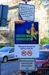 Hinweisschild des Bezirksamtes Hamburg Wandsbek auf den Wochenmarkt am Quarree.