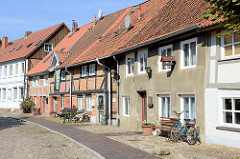 Denkmalgeschützte Wohnhäuser in der Großen Wallstraße von Boizenburg/Elbe; die Straße ist mit Kopfstein-Pflaster gepflastert.