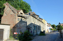 Architektur in Oderberg - Wohnhäuser in   unterschiedlichem Zustand der Bausubstanz  in der Angermünder Straße. Im Vordergrund ein verfallenes, leerstehendes Speichergebäude, dahinter ein denkmalgeschütztes Wohnhaus sowie Neubauten. Die schmale Str