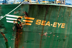 Das ehem. Rettungsschiff  Sea-Eye hat am Lotsenkanal im Hafen von Hamburg Harburg festgemacht; Schiffsname und  rostiger Anker am Schiffsbug.