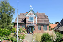 Fotos aus dem Hamburger Stadtteil Altengamme, Vierlande - Bezirk Hamburg Bergedorf. Wohnhaus mit Fachwerkgiebel und Wetterhahn; errichet 1911 - Architekt F. Kolbow; das Haus steht unter Denkmalschutz.