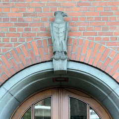 Fotos aus dem Hamburger Stadtteil Neugraben-Fischbek, Bezirk Hamburg Harburg. Eingang mit Adlerskulptur - ehem. Apothekergebäude in der Cuxhavener Straße, errichet 1951 - Architekt Johannes Stahmann; das jetzige Wohnhaus steht unter Denkmalschutz.