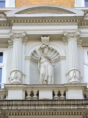 Historische Architektur in der Hamburger Innenstadt, Stadtteil Neustadt.  Figürlicher Bauschmuck zwischen Säulen - Hausfassade in den Colonnaden, 1878.
