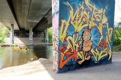 Bilder aus  Kiel - Landeshauptstadt von Schleswig-Holstein; Brücke vom Ostring über die Schwentine - Brückenpfeiler mit Graffiti  - Kanus auf dem Fluss.
