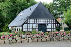 Sittensen ist eine Gemeinde im Landkreis Rotenburg (Wümme) in Niedersachsen;  Fachwerkhaus mit Feldsteinmauer - blühende Rosen.